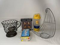 Photo showing the coffee pod holder, fruit basket, boxed Cambridge shot glasses, Mixol cocktail stirrers, and NutriBullet shaker bottle.