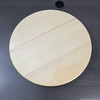 Top view of the larger wooden lazy susan showing a smooth light wood finish.