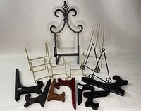 Photo showing all 14 easels including brass, wooden, and metal types in a grouped arrangement.
