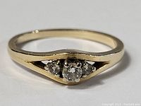 Front view showing central diamond flanked by two side diamonds in V-shaped gallery