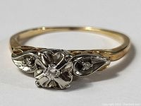 Front view showing central diamond and side settings