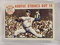 Front side of the 1964 Topps Sandy Koufax baseball card showing Koufax pitching with the text 'KOUFAX STRIKES OUT 15'.