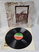 Vinyl record LP open with disc displayed in front of cover