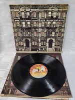 Front cover of Led Zeppelin Physical Graffiti album with opened gatefold showing vinyl disc with Swan Song label.