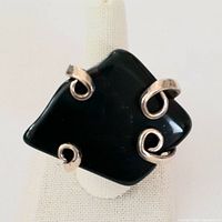 Front view of the antique Belfry fork ring with large bloodstone stone mounted with three silver scroll prongs