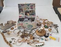 Overview of entire lot including decorative box, bracelets, necklaces, pendants and rings