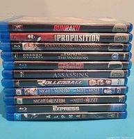 Stack of 11 Blu-ray cases showing movie titles on spine.