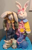 Two plush bunnies, trinket holder, blue color-changing bunny on blue surface, part of the set