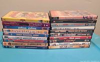 Two stacked stacks of DVDs showing titles from various comedy and cartoon movies titles in their cases.