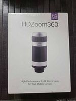 Front of sealed HDZoom360 box showing lens image and product name