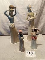 All four ceramic figurines shown together, displaying scale and detail