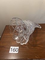 Crystal horn of plenty decorative vase standing on its open flared end, showing scalloped edges and detailed cut designs