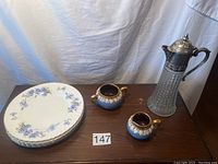 Four blue floral cornflower pattern dinner plates with gold plated trim stacked, shown with cream and sugar set and coffee decanter