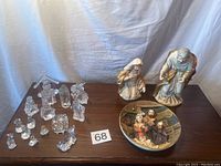 Overall view of clear plastic nativity figurines, ceramic nativity plate, and ceramic Mary and Joseph statues