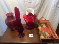 Full lot view showing three vases and serving tray arranged on wood surface against white draped background.