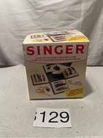 Box of the Singer 70-piece foldable sewing cube showing product graphics and description on front.
