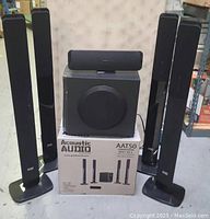 Photo showing the four tower speakers, center speaker on top of subwoofer, and AAT50 box below.
