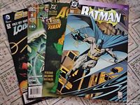 Five DC comic books fanned out, displaying Batman #500, Aquaman #1, Sinestro vs Lobo #15, Flashpoint #3, and Flash 1st issue covers.