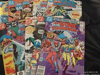Lot of All Star Squadron comic books laid out, showing colorful front covers with superhero group and action scenes.