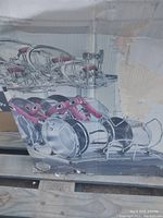 Photo of wire rack shelves holding pots and pans with red handles, showing the kit components.