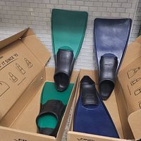 Two pairs of Finis long floating swim fins each in their respective boxes, one pair green with black foot pockets, one pair blue with black foot pockets, showing used but good condition.