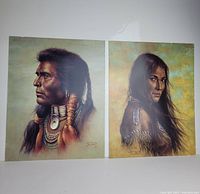Pair of vintage art prints depicting Indigenous Native American man and woman shown side by side, unframed, with visible artist signature and detailed traditional jewelry/garments.
