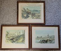Three framed vintage art prints depicting Montreal, Quebec scenes with people, horses, ships, and buildings, all arranged on carpeted floor.