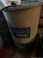 Kenmore central vacuum main unit with visible branding and connected black base