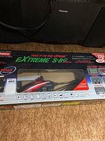 Front view of the unopened Extreme S-8g remote controlled helicopter box showing the helicopter inside through the clear plastic window and main branding.