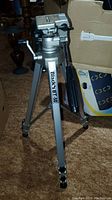 Vintage Blacks BT-50 tripod standing upright, showing three aluminum legs, black handle, and mounting head with adjustment controls. Branding visible on one leg.