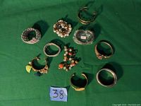 Top-down photo of assorted bracelets on green fabric background