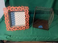Photo of small decorative coral painted square wooden shelf and a wire mesh side wooden box shelf