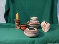 Photo showing the full group of five Southwest style pottery items on green cloth background.