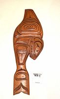 Front view of the hand-carved wooden whale wall plaque in warm brown wood with detailed indigenous motifs.