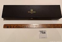 Closed original box with Skultuna branding and a measuring scale for size reference.