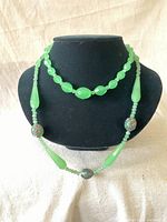 Both necklaces displayed on black necklace display, showing overall length and bead design for each.