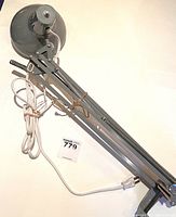 Full side view of the vintage Luxo lamp, showing articulated arm, clamp base, and power cord.