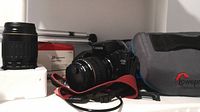 Wide view of Canon EOS A2E body with attached 28-105mm lens, EF 100-300mm lens, tripod, and Lowepro bag