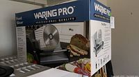 Original box of Waring Pro food slicer showing image of device and brand