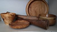Photo of various turned wooden vases, bowls, burled wood plate, and condiment bowls, showing wood grain and natural coloration.