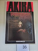 Front cover of Akira #1 comic book, featuring bold red title and urban scene illustration.