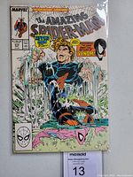 Comic book cover showing Hydro-Man holding Spider-Man out of water with Venom appearance text and imagery.