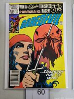 Front cover of Daredevil #179 comic book showing Elektra with a sai and a shredded Daredevil mask.