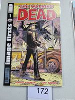 Front cover of The Walking Dead #1 comic book showing a sheriff in front of destroyed surroundings.