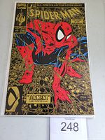 Front cover of Spider-Man #1 gold version comic book showing detailed colorful illustration and gold foil background.