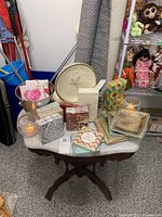 View of round paper plates and several packs of colorful patterned paper napkins along with two battery operated candles on a small table.