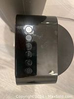 Top control buttons of a Lasko space heater showing power, plus, minus, and other function buttons