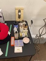 Photo showing vanity tray with various hand soaps, lotions, and decorative bowl along with a decorative wall hanger with door handle design visible behind.