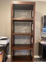 Front view of the wood display shelf unit showing five flat shelves and rectangular frame construction.