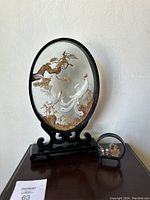 Full view of the set showing both sculptures side by side on a wooden surface against a white wall.